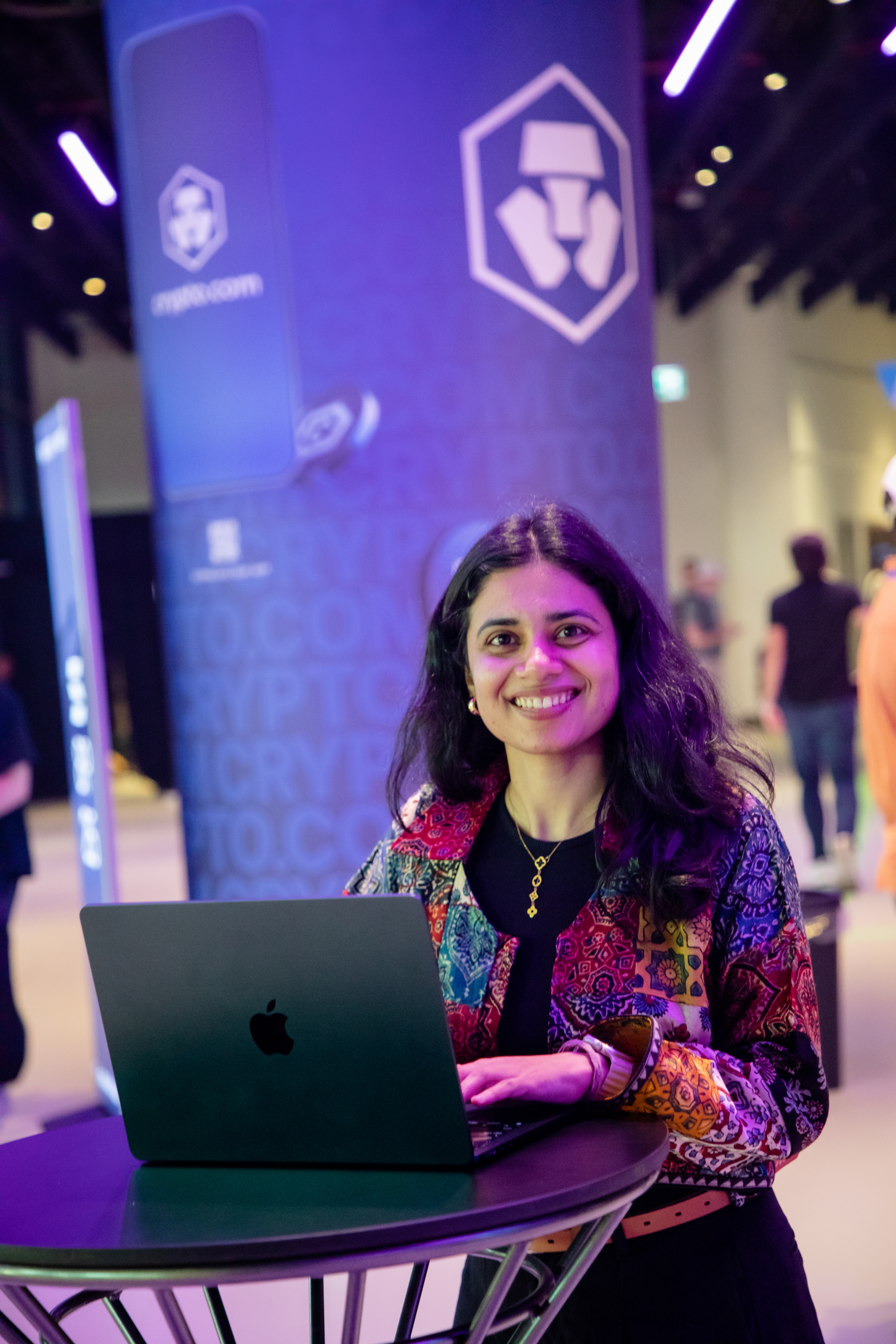 Nidhi Singh at a blockchain event with her laptop